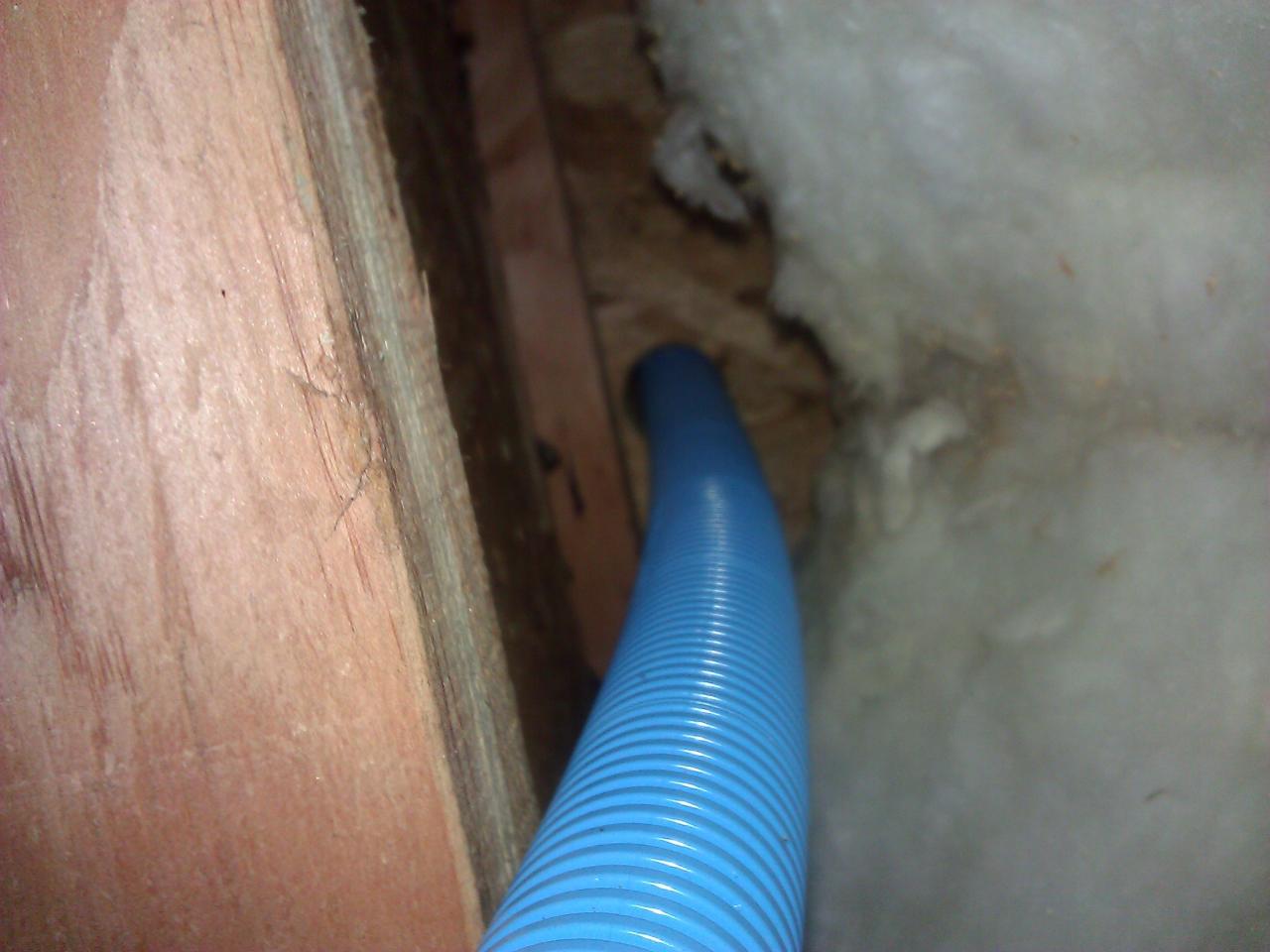 Conduit fed upward into the space behind the fireplace
