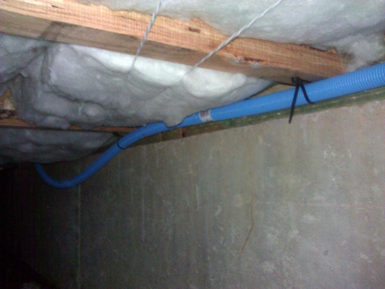 Strapping the conduit to the floor joists